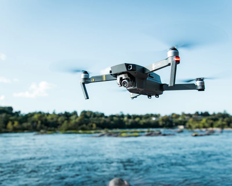 Camera drone in flight over water
