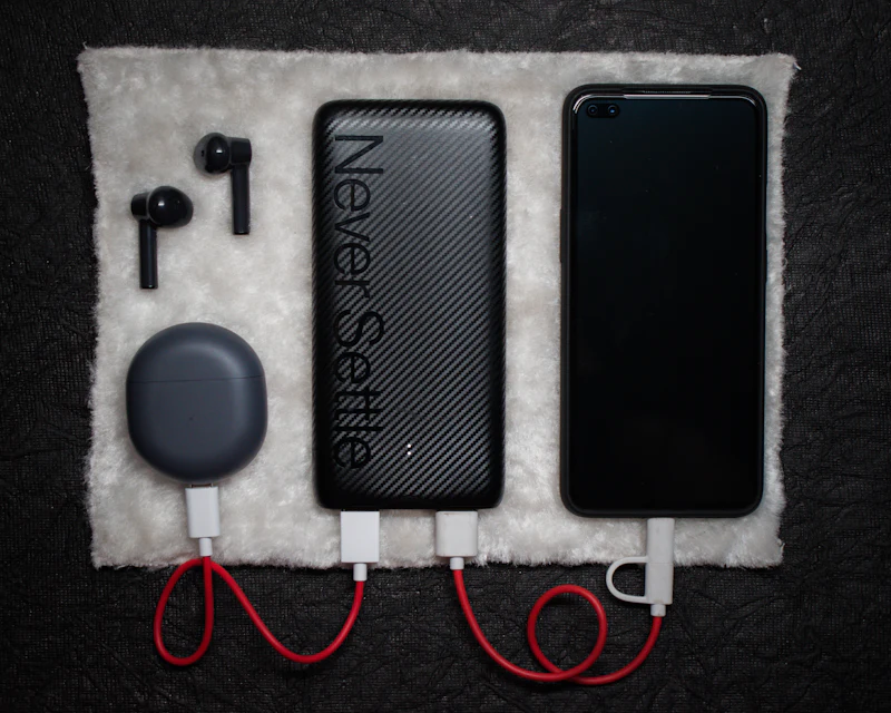 Magnetic power bank and wireless earbuds on a textured surface
